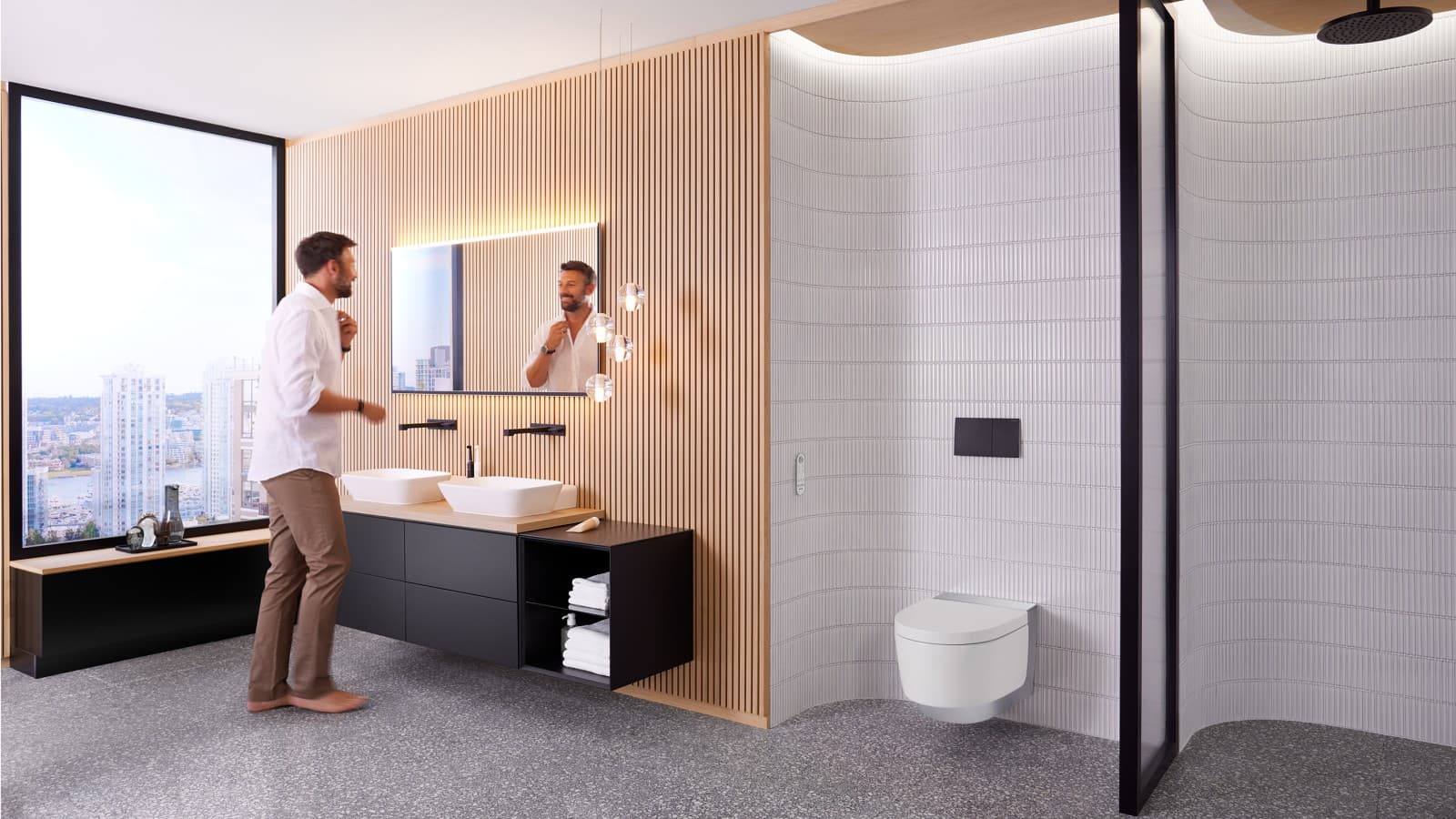 Mann in Badezimmer vor Spiegel Geberit Option Plus Square und schwarzen Geberit ONE Badmöbeln (© Geberit) Mann in Badezimmer vor Spiegel Geberit Option Plus Square und schwarzen Geberit ONE Badmöbeln (© Geberit)